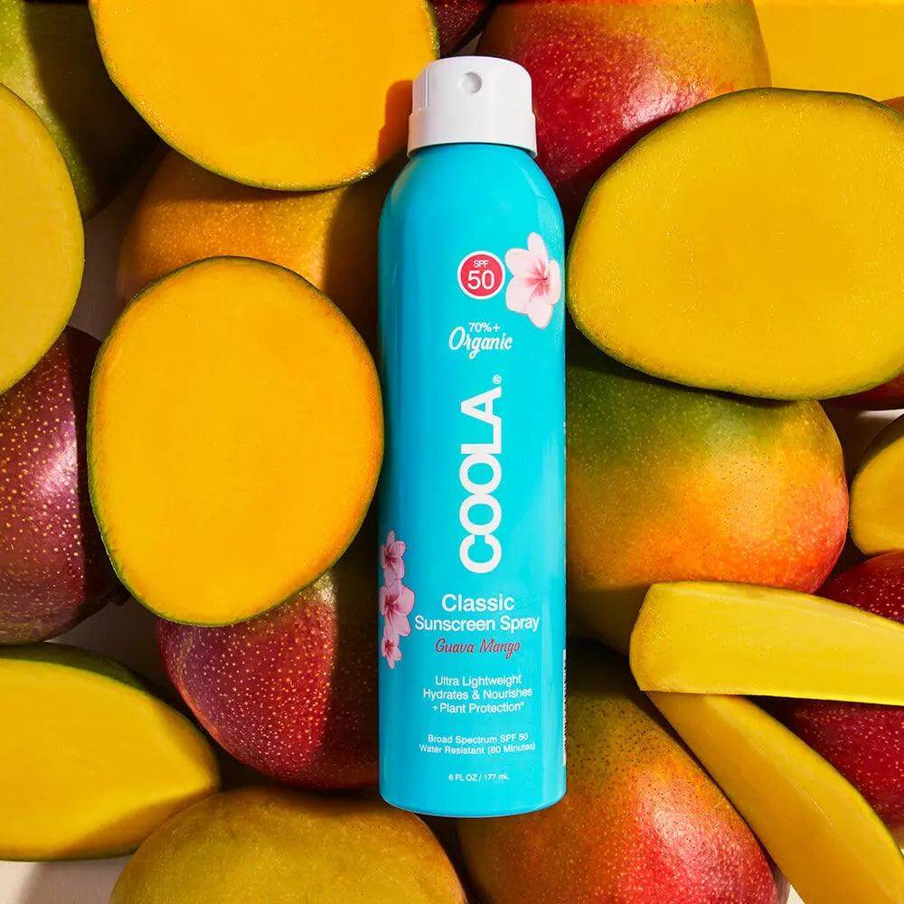 Classic Body Organic Sunscreen Spray SPF 50 Guava Mango with mangoes background, featuring antioxidant-rich Plant Protection formula.