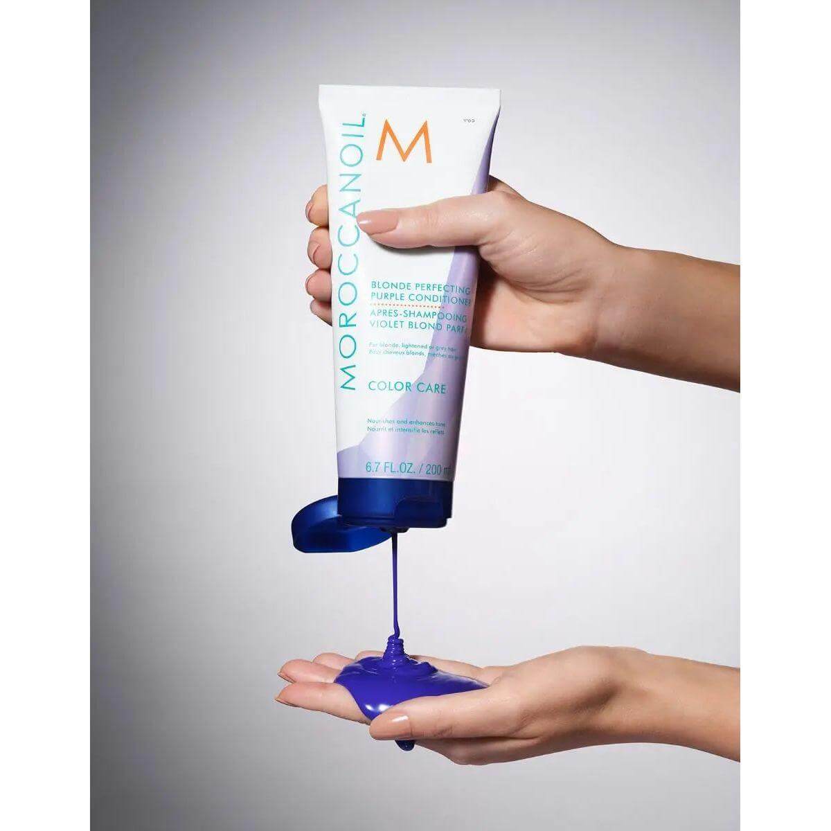 Person pouring Moroccanoil Color Care shampoo into their palm
