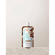 Moroccanoil Color Depositing Mask 30ml on marble surface, restores hair color and shine with argan oil conditioning formula.