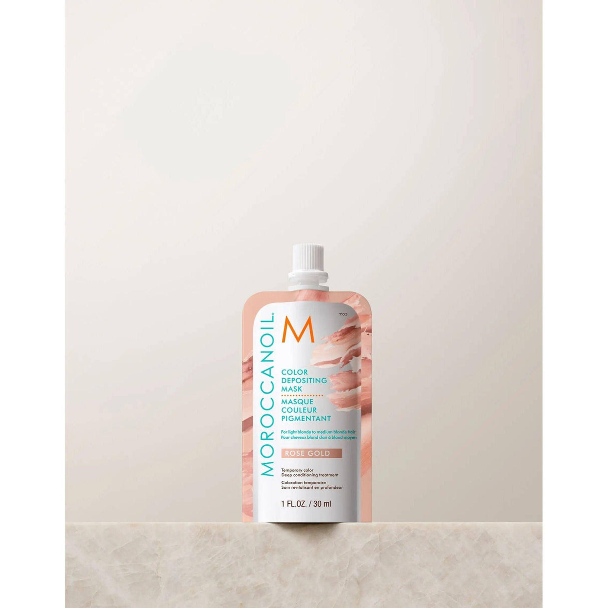 30ml Moroccanoil Color Depositing Mask on marble surface. Intensively conditions hair and refreshes color with glossy argan oil finish.