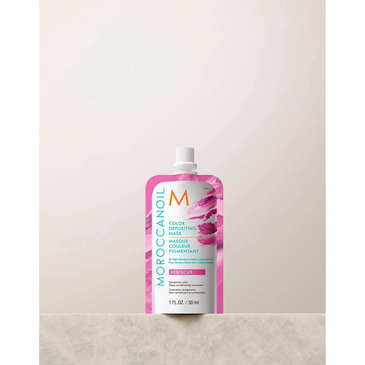 Moroccanoil Color Depositing Mask in Hibiscus 30ml, enhances hair color and shine with argan oil, perfect for refreshing between salon visits.