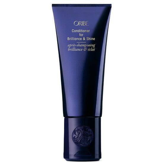 Oribe Conditioner for Brilliance & Shine in navy tube packaging, enhancing hair shine and detangling without dullness.