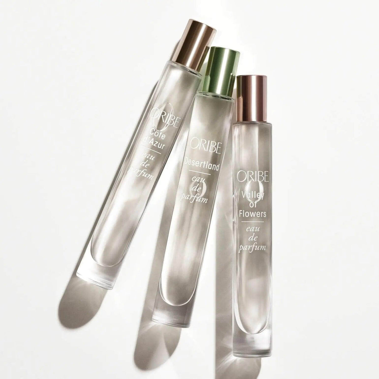 Côte D'Azur Eau De Parfum bottle trio featuring citrus, jasmine, and sandalwood notes; luxury travel fragrance collection.