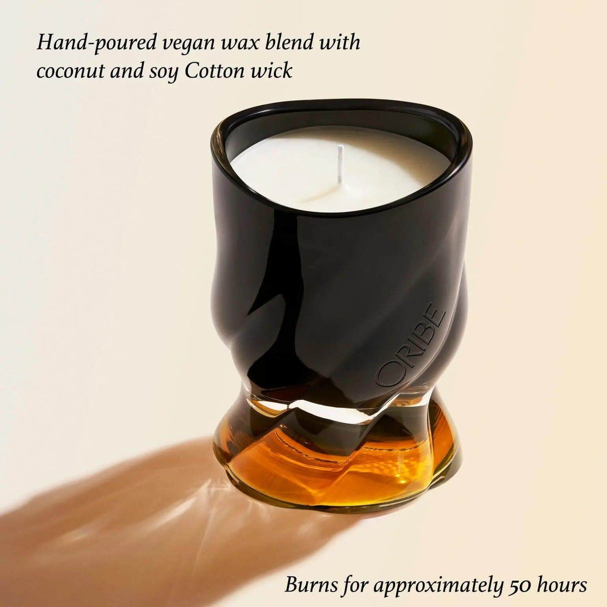 Côte d'Azur scented candle by Oribe in a stylish glass holder, offering a 50-hour burn time with coconut and soy wax blend.