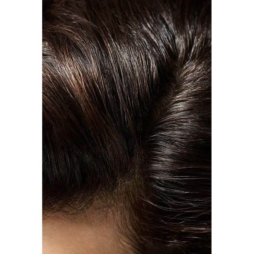 Close-up of glossy, well-styled hair showcasing the smoothing effects of Crème For Style hair cream.