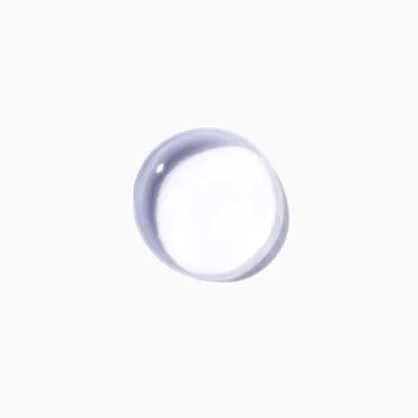 Close-up of Kérastase Cure Apaisante Intense scalp treatment drop on white background.