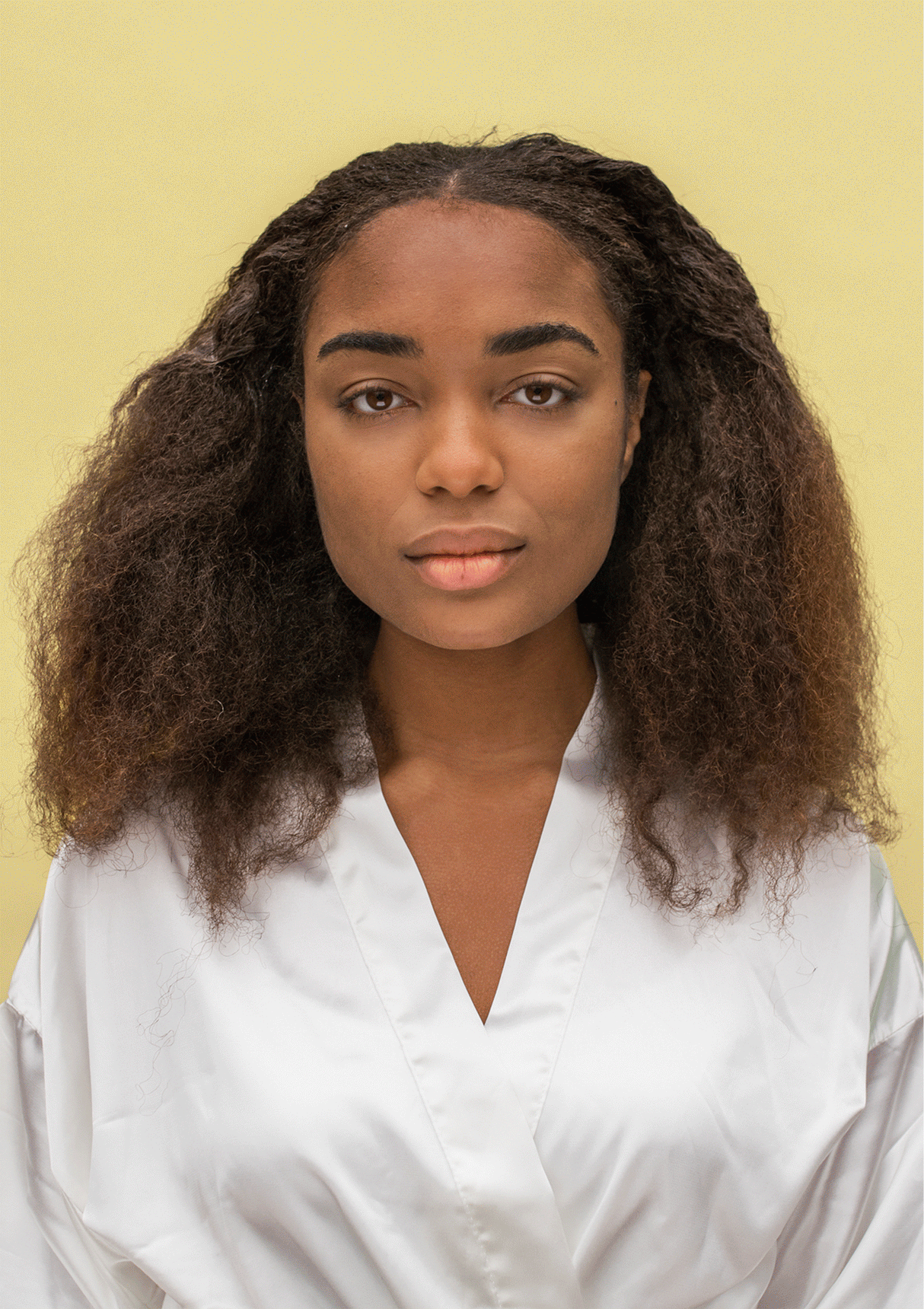 Transformation of natural curls with Curl Discovery Kit products, showcasing bouncy and defined curls.