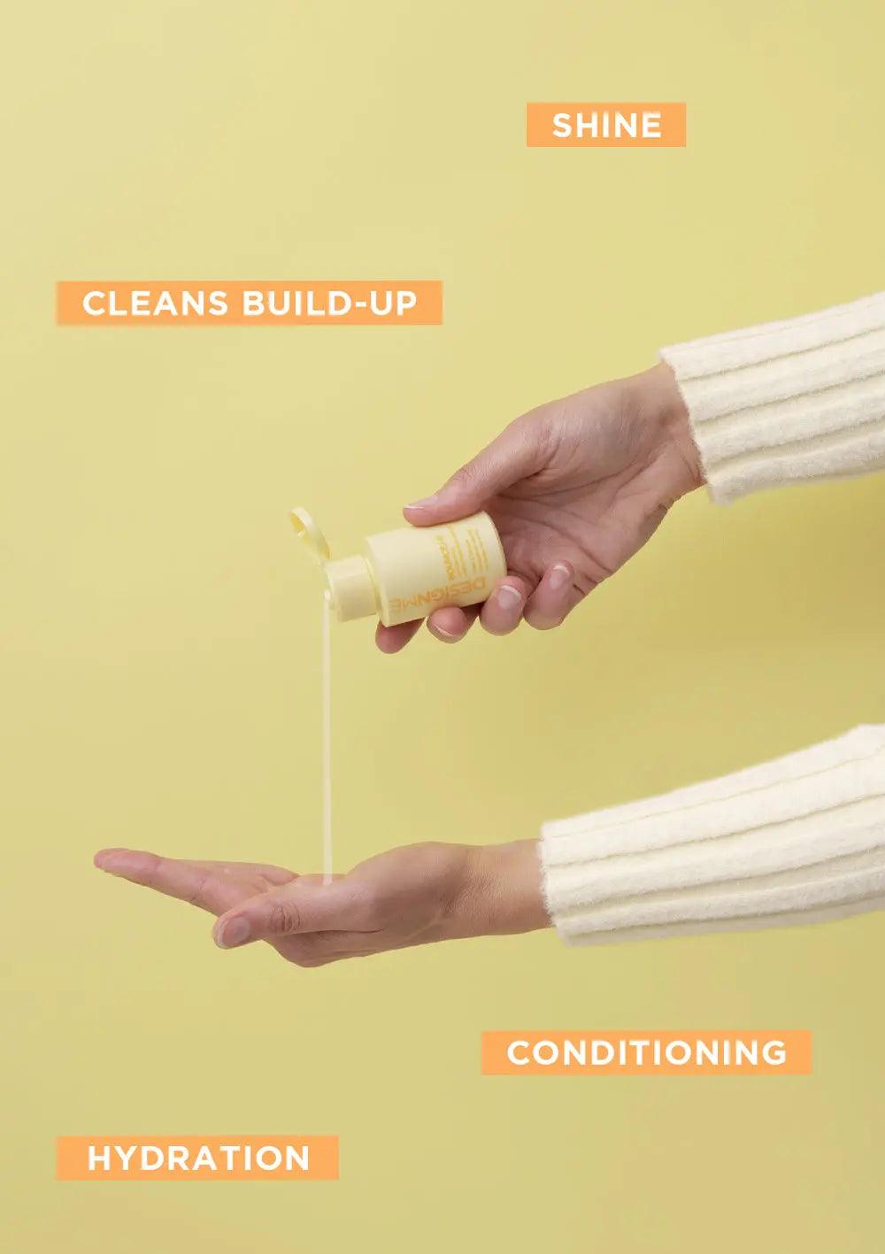 Person pouring curl shampoo from a yellow bottle onto their hand, emphasizing shine, hydration, conditioning, and build-up cleansing.