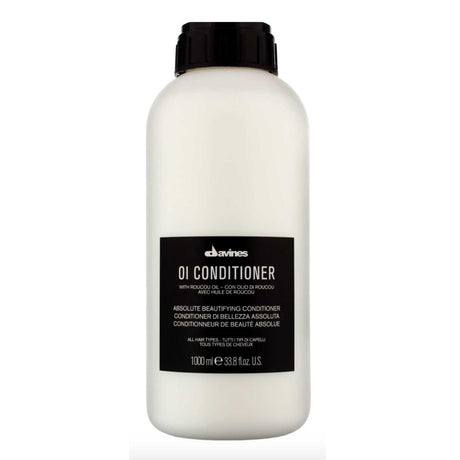 Davines Essential Haircare OI Conditioner Liter bottle for nourishing, shiny hair with UV protection and quick drying benefits.