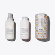 Davines Defined Coils Set with Love Curl Primer, Love Curl Controller, and Medium Hold Modeling Gel for enhancing curly hair.