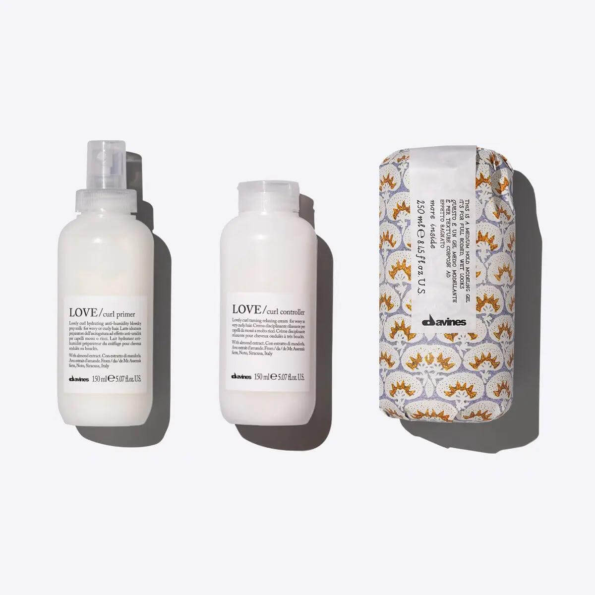 Davines Defined Coils Set with Love Curl Primer, Love Curl Controller, and Medium Hold Modeling Gel for enhancing curly hair.