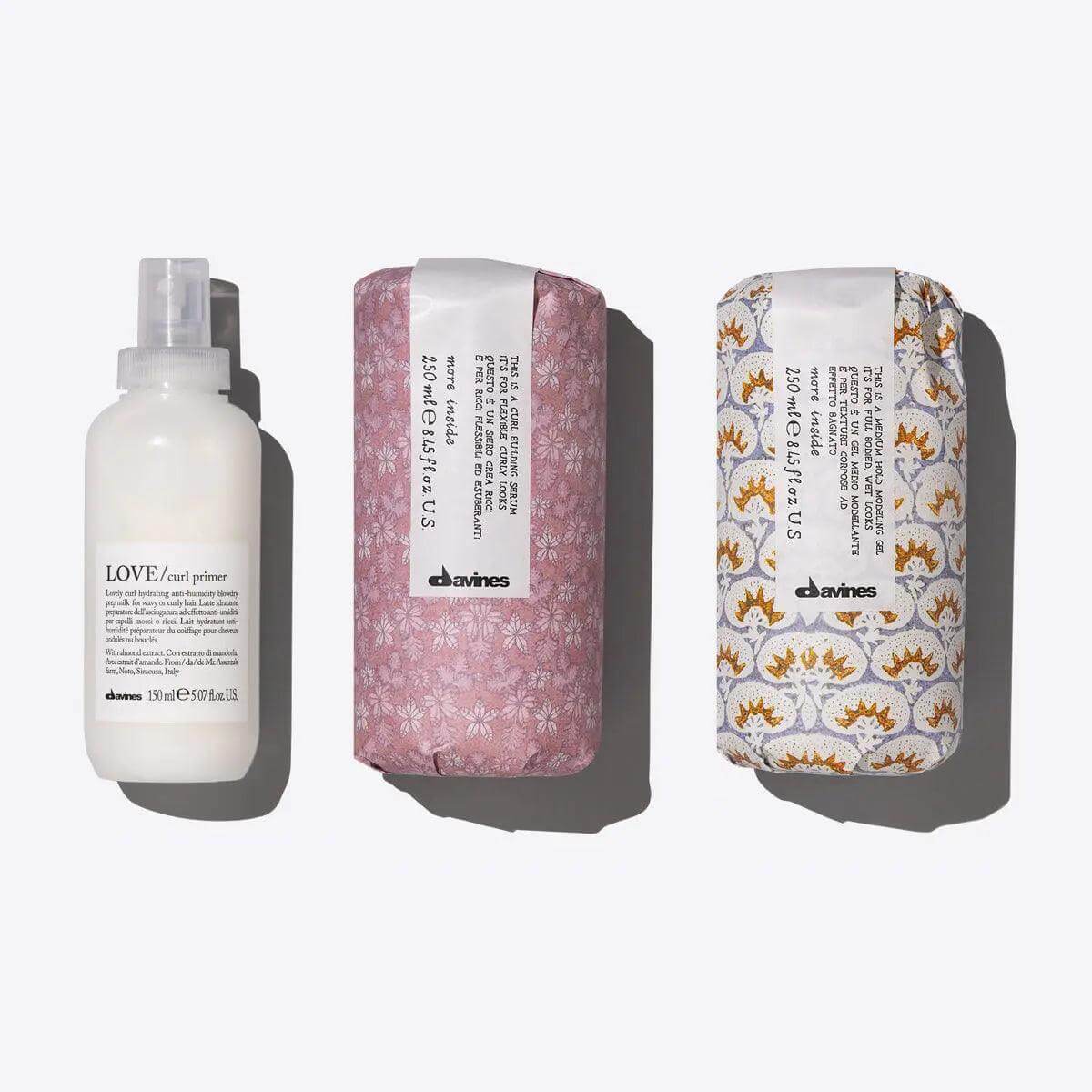 Davines Defined Waves Set featuring Love Curl Primer, Curl Building Serum, and Medium Hold Modeling Gel for defined, bouncy waves.