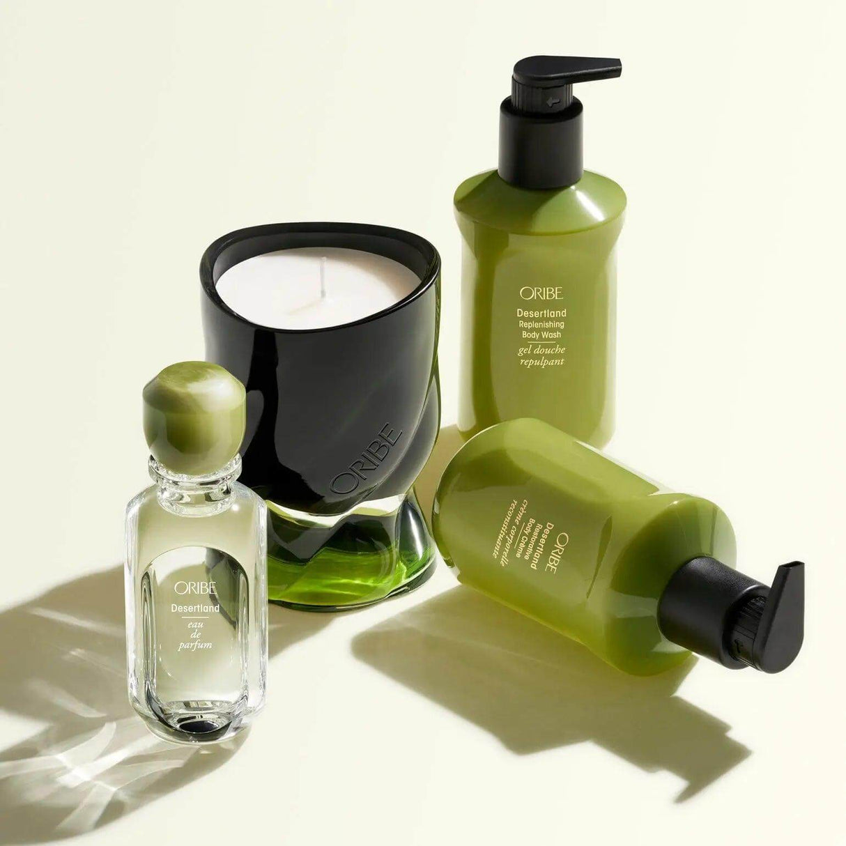 Oribe Desertland Body Crème and other luxury skincare products elegantly arranged on a neutral background.