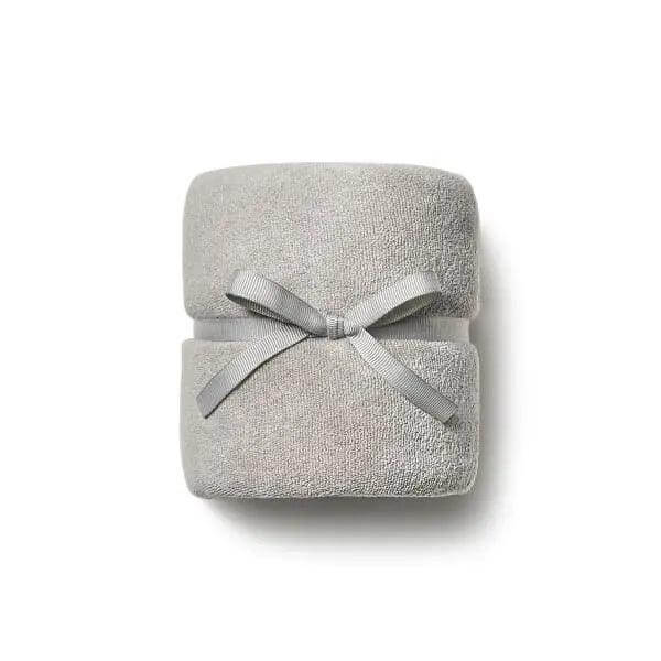 Soft gray DevaTowel designed for curly hair, enhances curl definition and reduces frizz, tied with a ribbon, size 39" x 20".