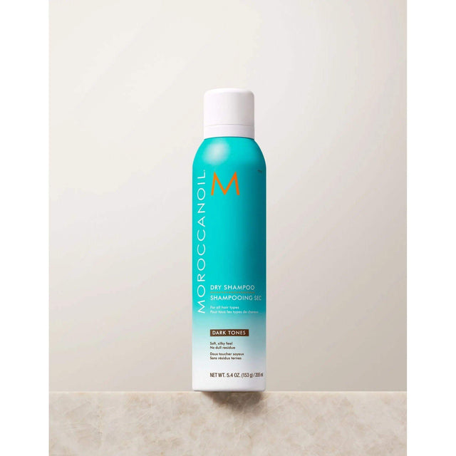Moroccanoil Dry Shampoo for Dark Tones, 5.4 oz bottle, ideal for absorbing oil and enhancing dark hair color with UV protection.