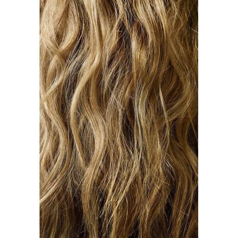 Wavy blonde hair showcasing volume and texture achieved using Dry Texturizing Spray, perfect for styling and taming flyaways.