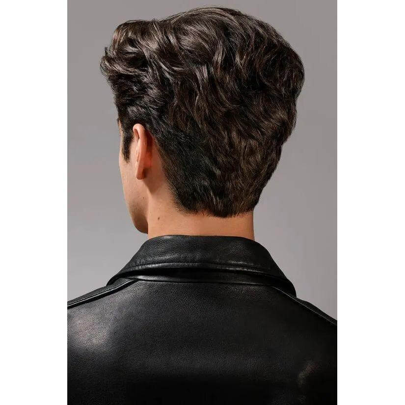 Man with styled hair using dry texturizing spray, wearing a black leather jacket, showcasing voluminous clean hairstyle.