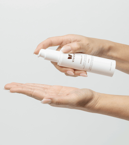 Hands applying Vivier DERMA-V cream, lightweight award-winning formula for enhanced skin hydration and barrier protection.