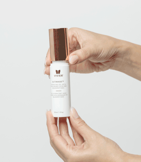 Hands holding Vivier Ultimage™ gel bottle for hydration with Hyaluronic Acid and Neuropeptides, suitable for all skin types.