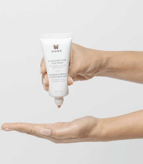 Vivier Ultra Purifying Clay Mask in hand, showing skincare treatment tube with Kaolin clay and AHAs for exfoliating and hydrating benefits.