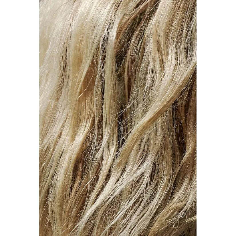 Close-up of layered blonde hair styled with Flash Form Finishing Spray Wax for a natural, airy texture effect.