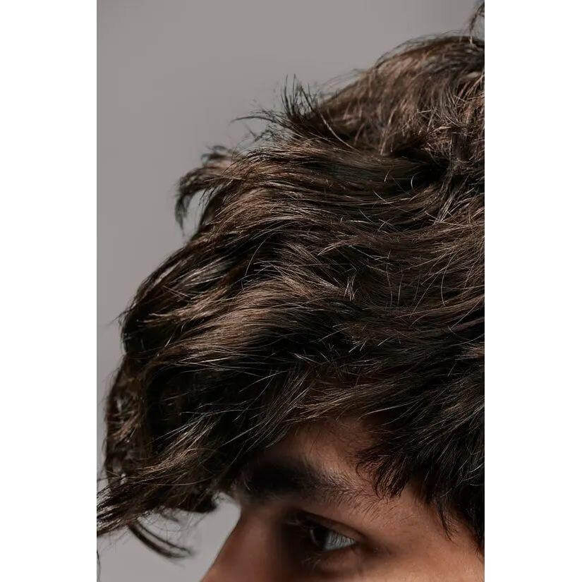 Close-up of styled hair with natural texture using Flash Form Finishing Spray Wax for men.
