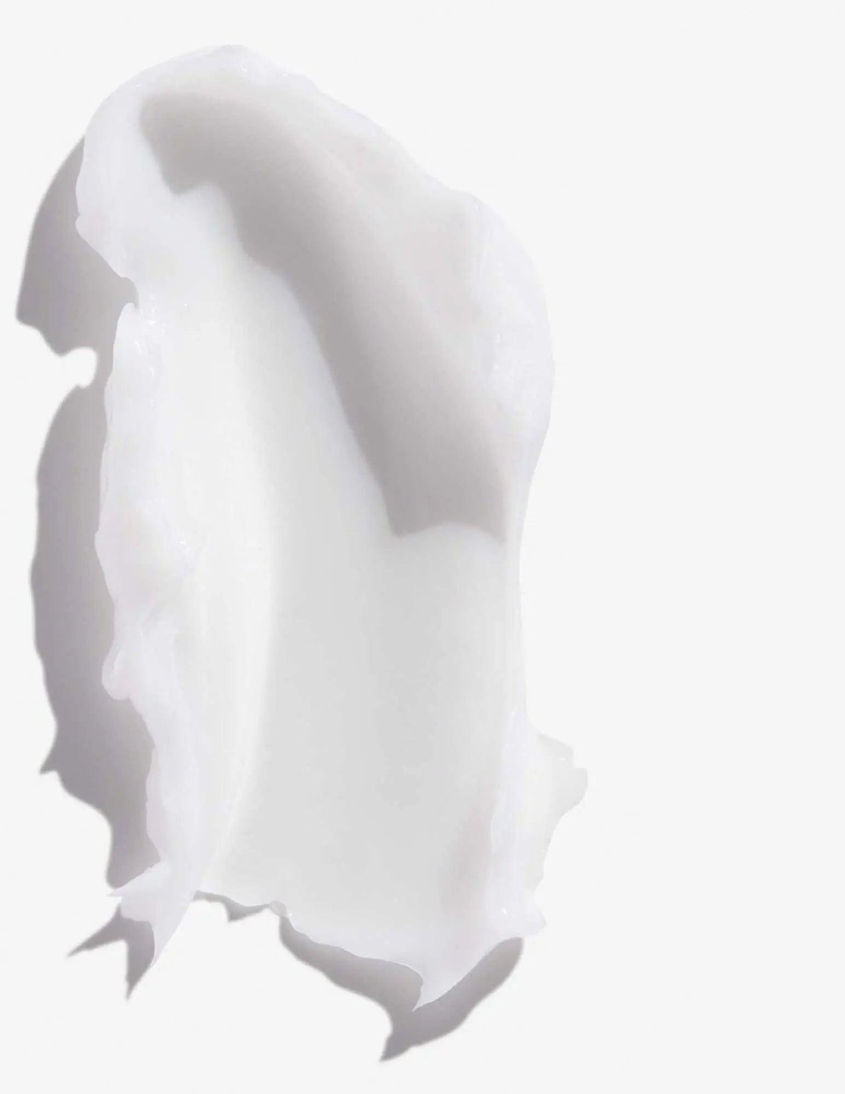 Creamy texture of Frizz Dismiss Conditioner for reducing frizz and enhancing smoothness on all hair types.