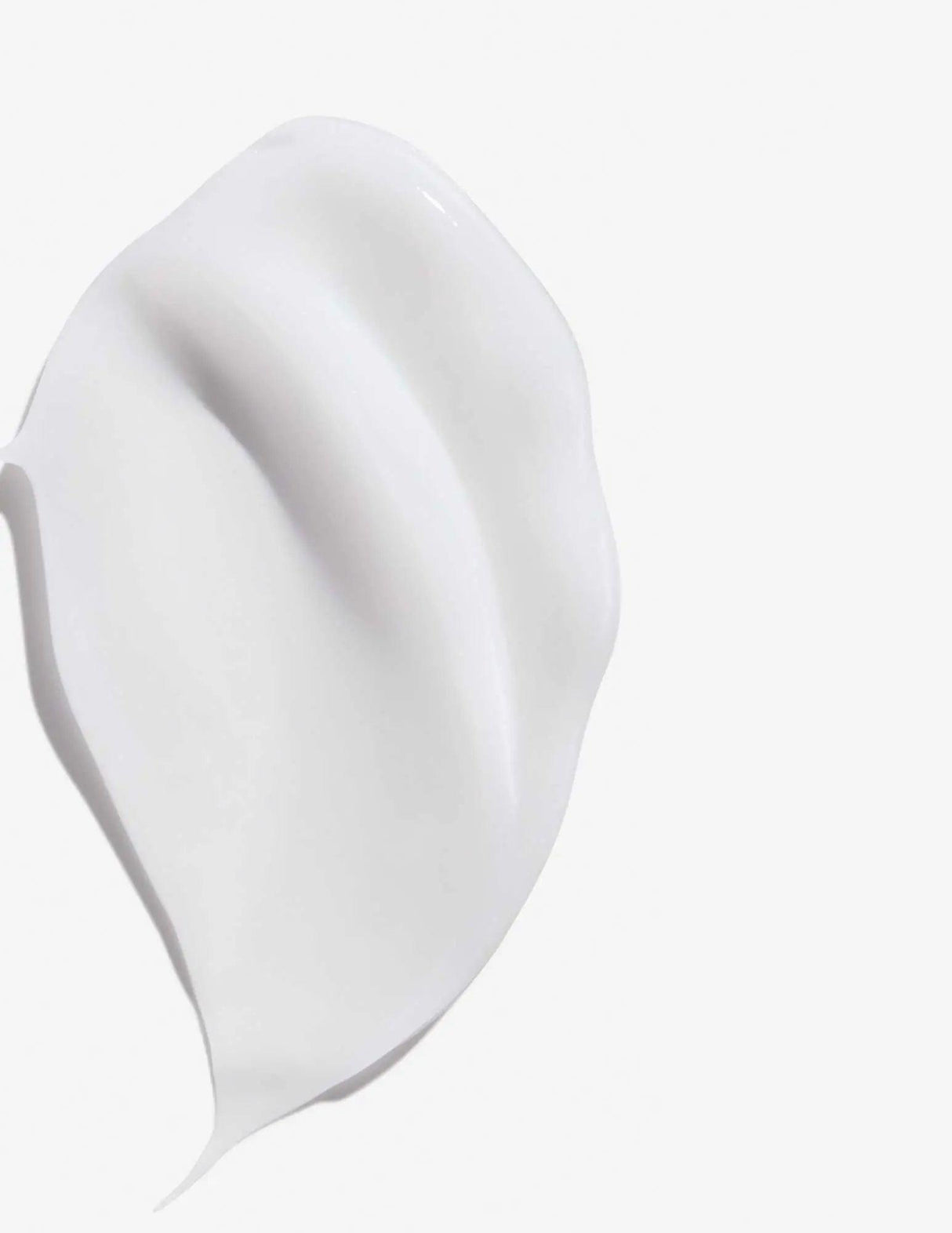 Smooth texture of Frizz Dismiss Rebel Tame Cream shown against a white background, highlighting its creamy consistency.