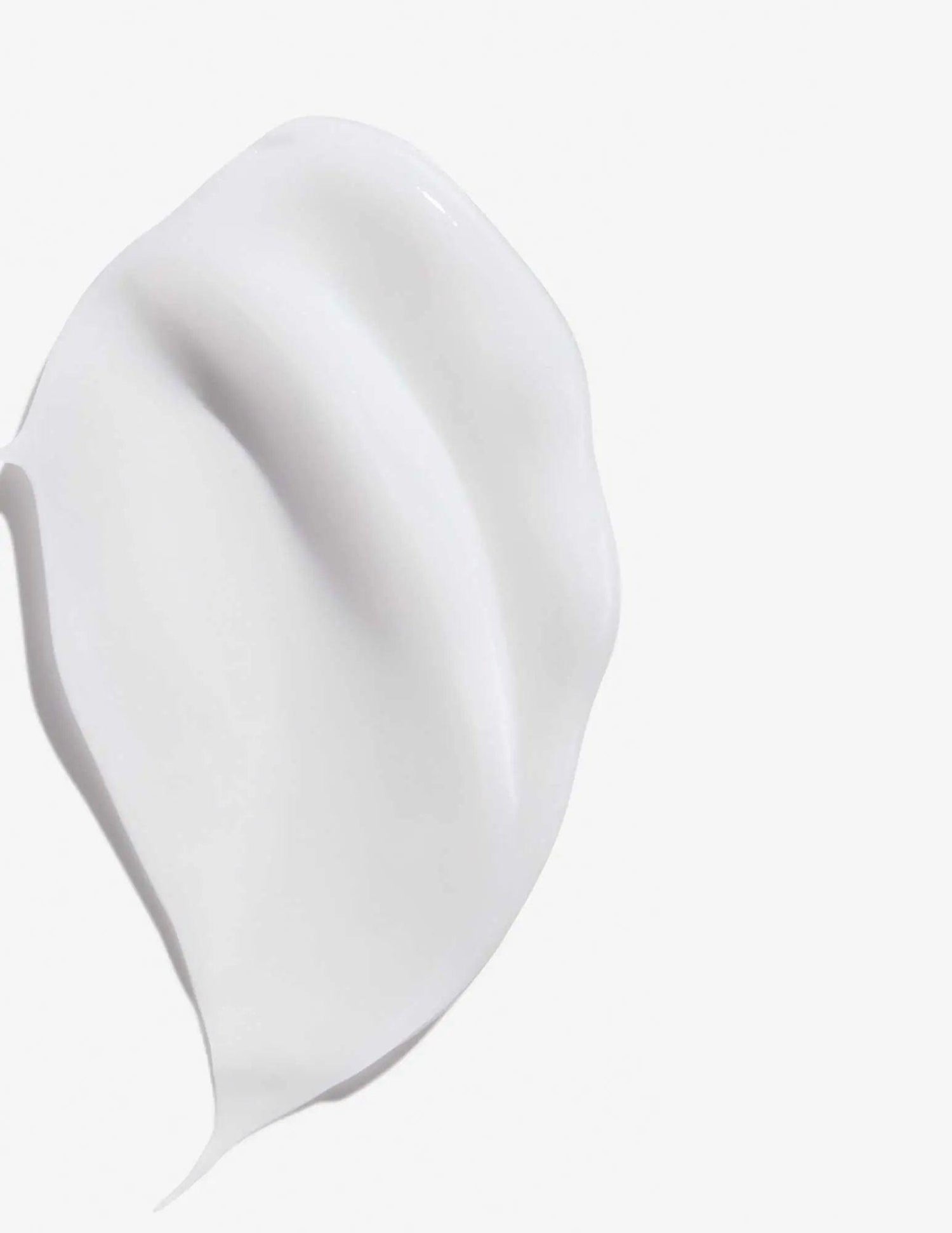 Smooth texture of Frizz Dismiss Rebel Tame Cream shown against a white background, highlighting its creamy consistency.