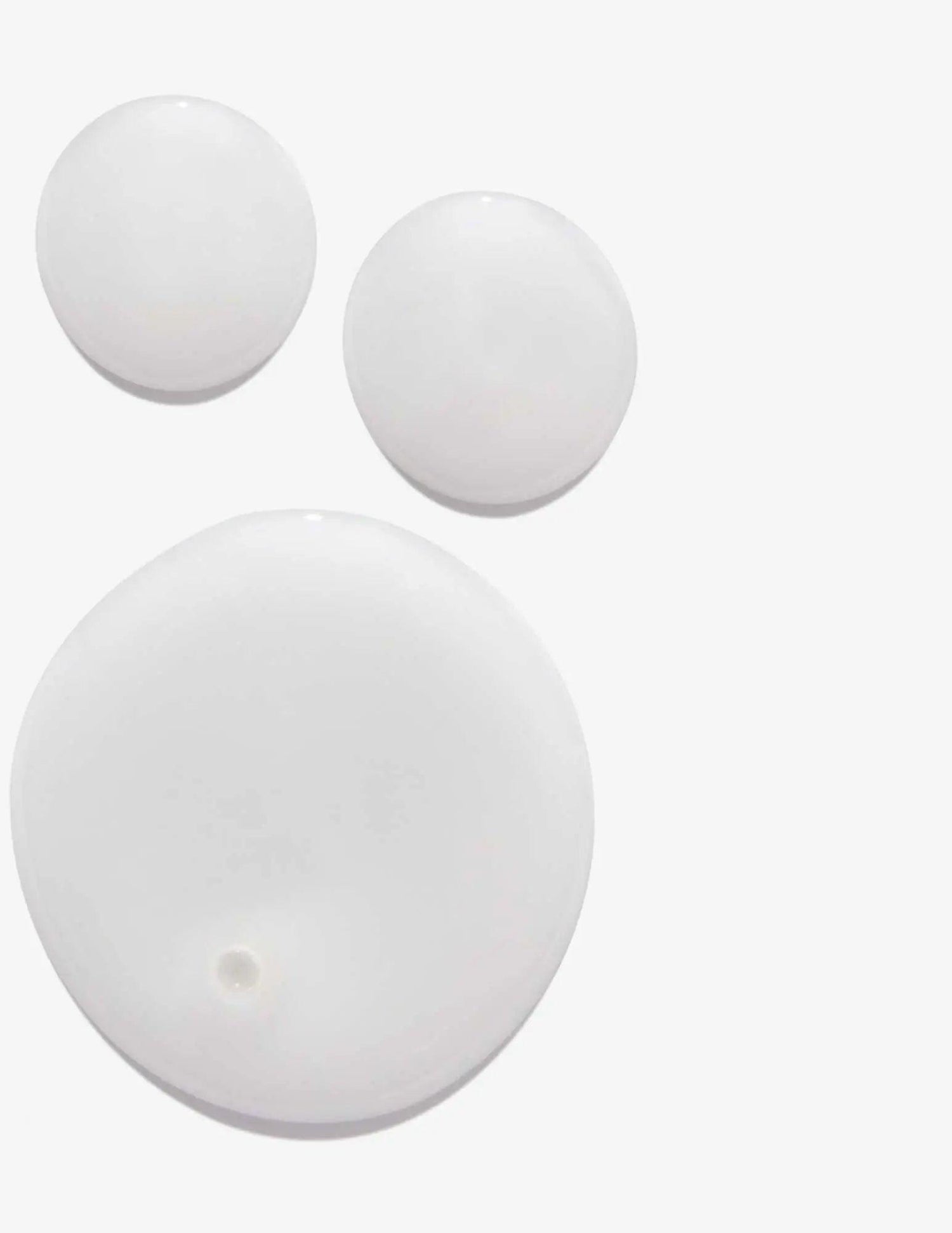 Redken Frizz Dismiss Shampoo swatch showing smooth, creamy texture for reducing frizz.