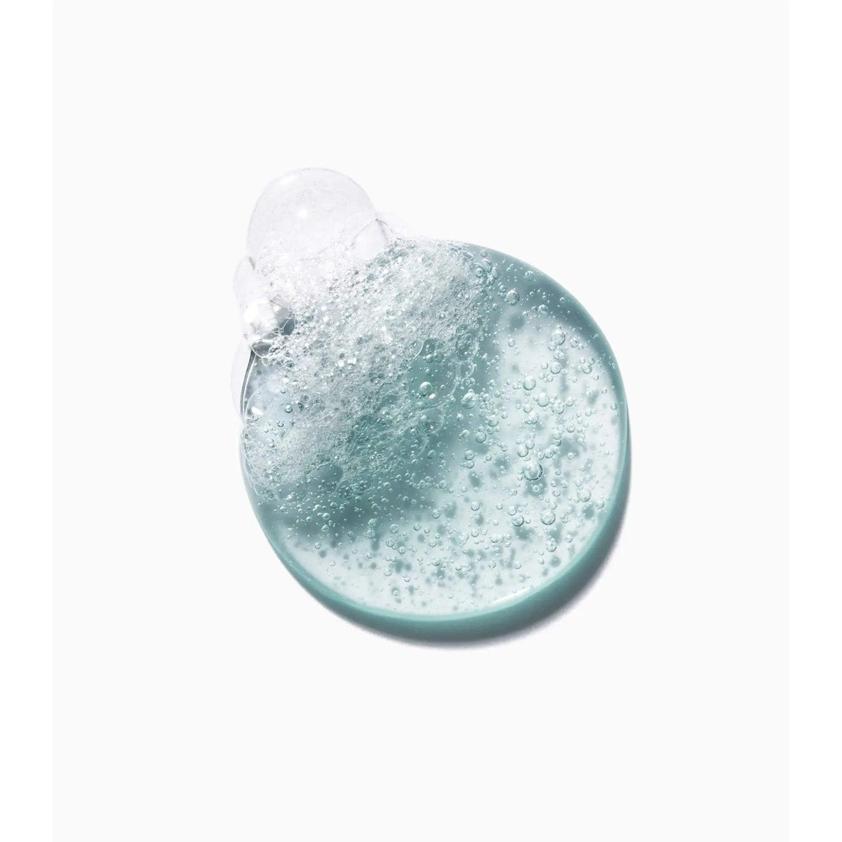 Close-up of Kérastase Genesis Homme Bain de Force Quotidien Shampoo texture with bubbles, showcasing its invigorating formula.