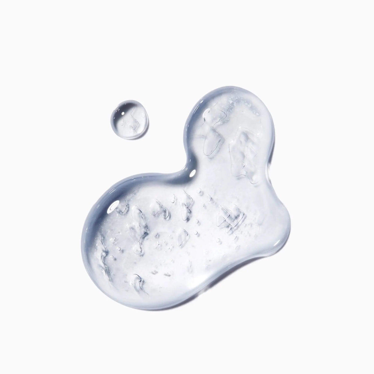 Close-up of Kérastase Genesis Homme Sérum Anti-Chute Fortifiant texture on a white background.