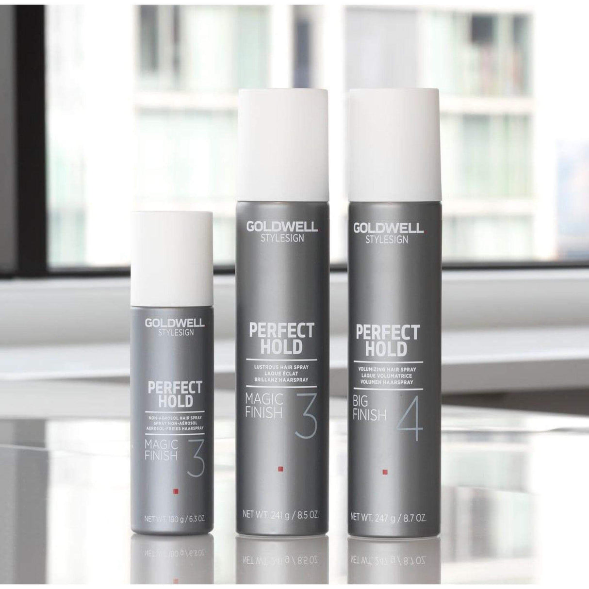 Goldwell Perfect Hold Magic Finish Hairspray bottles in different sizes, offering light to medium hold with natural movement and shine.