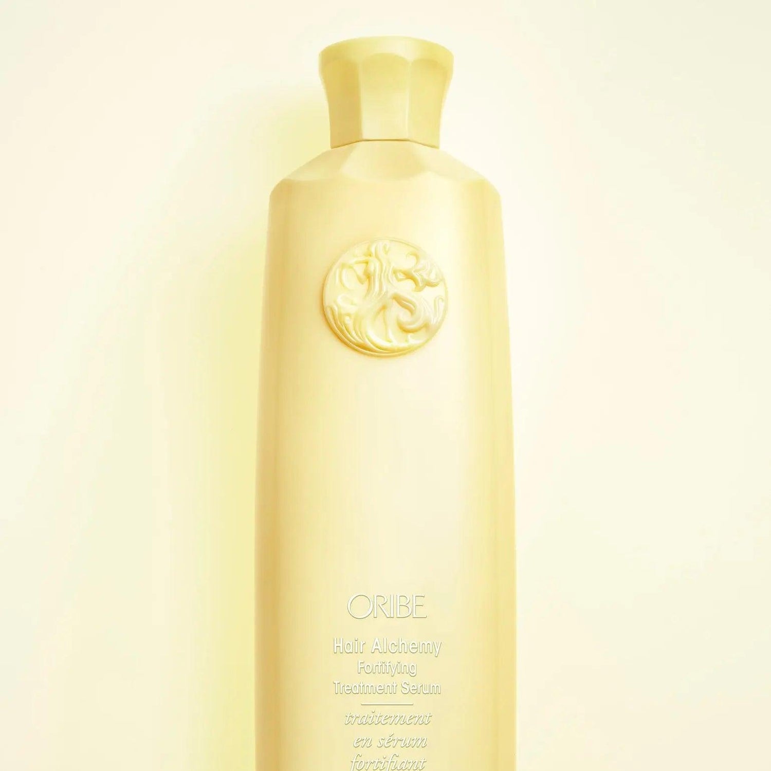 Oribe Hair Alchemy Fortifying Treatment Serum bottle, features chia seed and cotton seed extract for stronger, healthier hair.