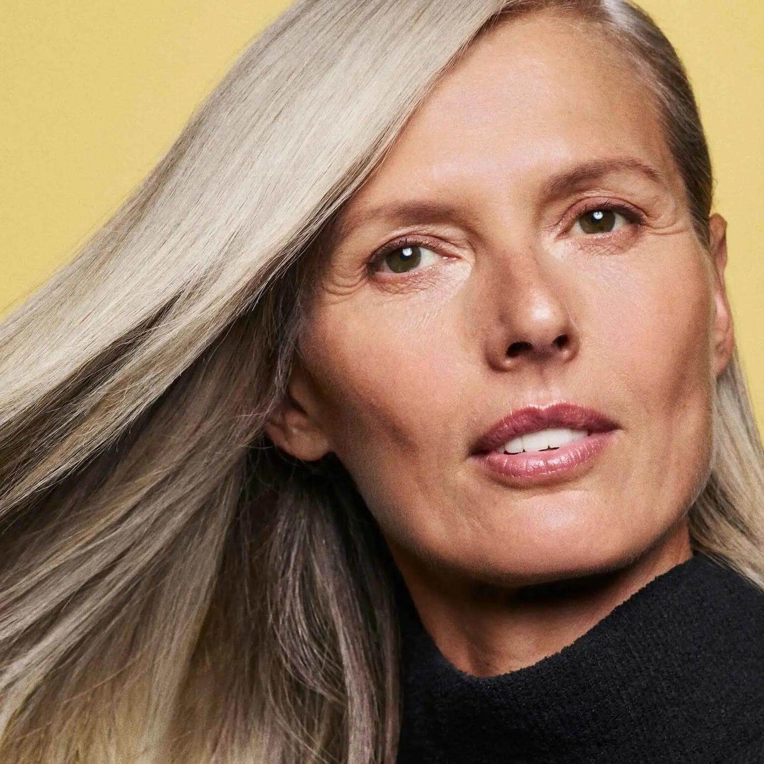 Person with smooth, shiny hair demonstrating the effects of Hair Alchemy Resilience Conditioner.