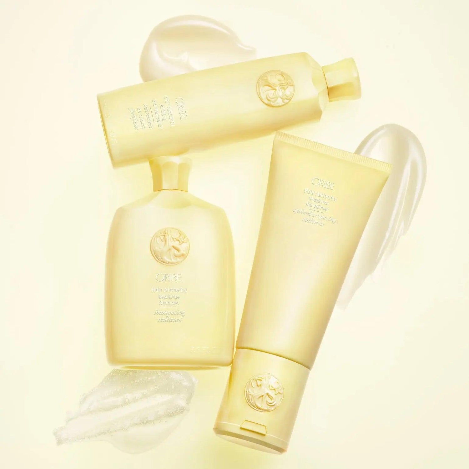 Hair Alchemy Resilience Shampoo bottles and cream swatches on a light background, promoting hair strength and protection.