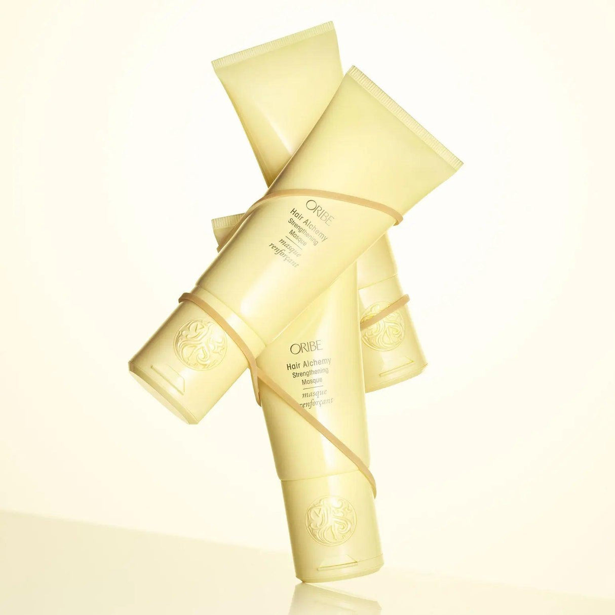Oribe Hair Alchemy Strengthening Masque with shea butter and yacón root for revitalizing and fortifying delicate hair.