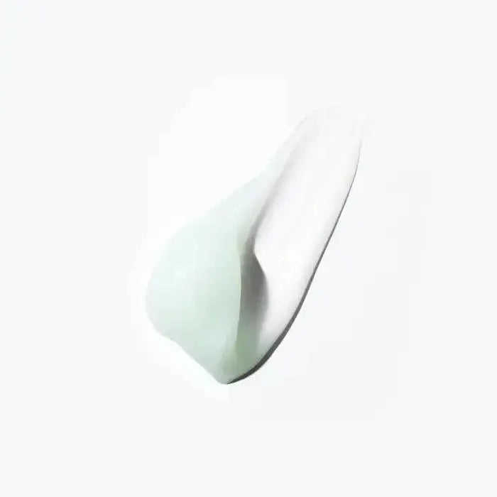 Texture of Kerastase Spécifique Masque Réhydratant, a nourishing hair mask for dry and sensitive scalps, shown in creamy white and green hues.