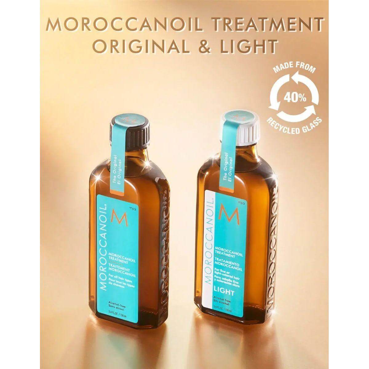 Two bottles of Moroccanoil Light Treatment for fine hair infused with argan oil, featuring signature scent, on recycled glass backdrop.
