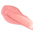 Close-up of pink lip color serum swatch with a glossy finish, highlighting its nourishing, natural ingredients and hydrating properties.