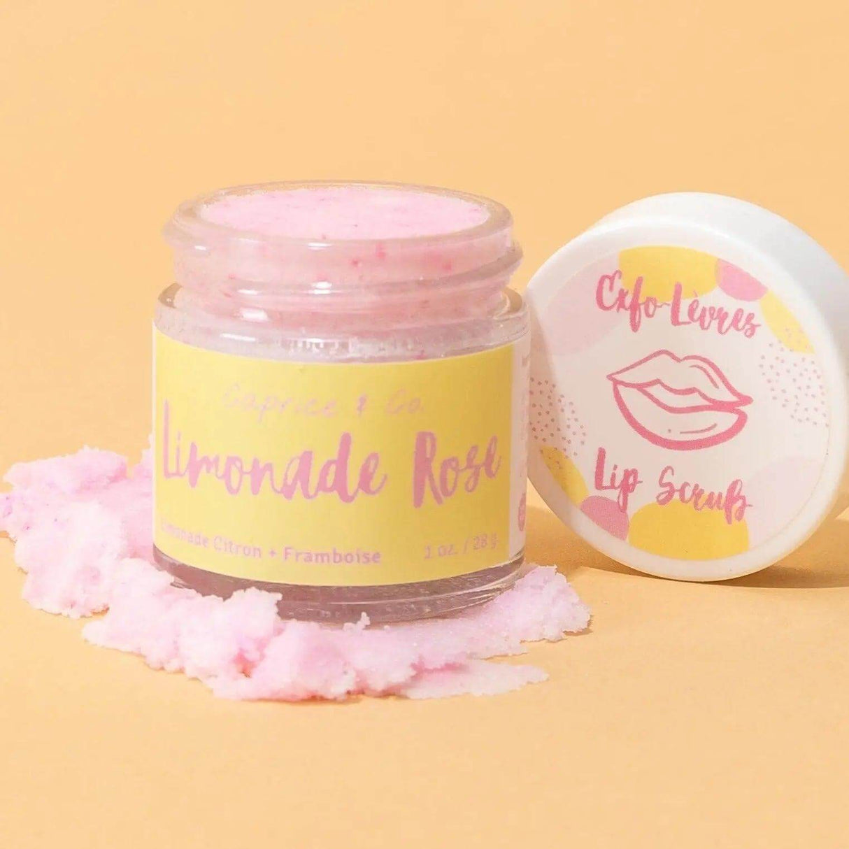 Limonade Rose Lip Scrub in jar with pink color on a light background, lemon and raspberry flavor, 1oz jar for gentle exfoliation and hydration.