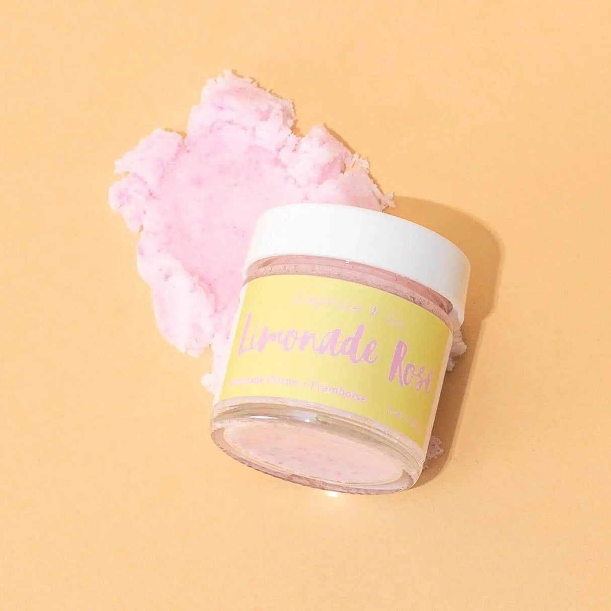 Lip Scrub Limonade Rose 1oz jar with pink texture, featuring refreshing lemon and raspberry flavors, perfect for lip exfoliation.
