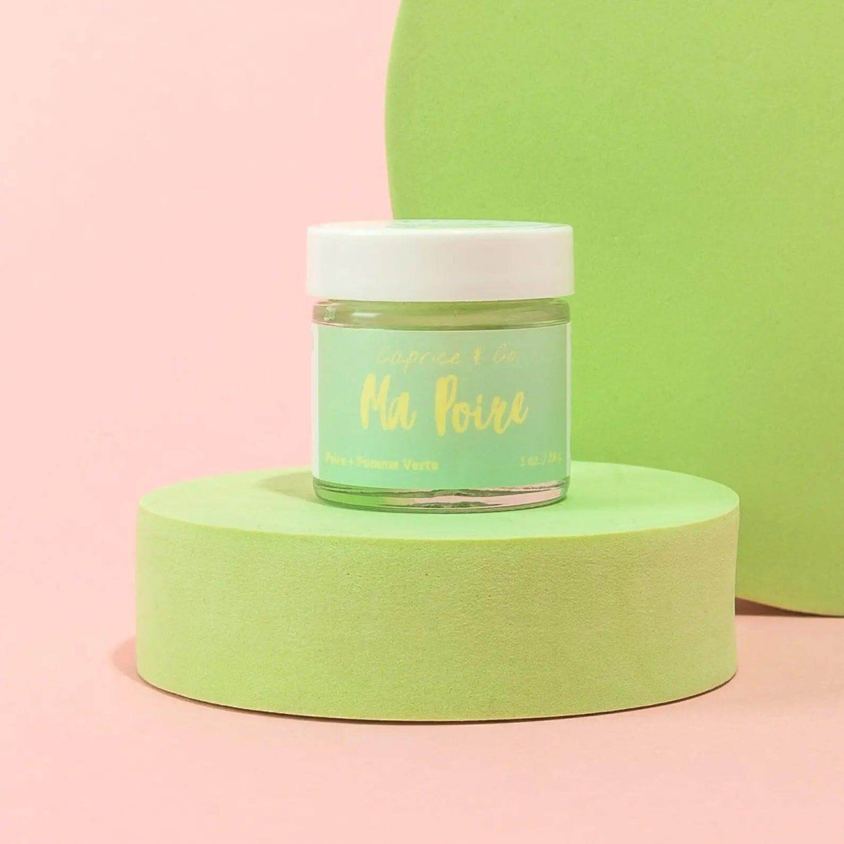 Lips Scrub Ma Poire jar with green and pink background, featuring pear and green apple flavors for lip exfoliation and hydration.