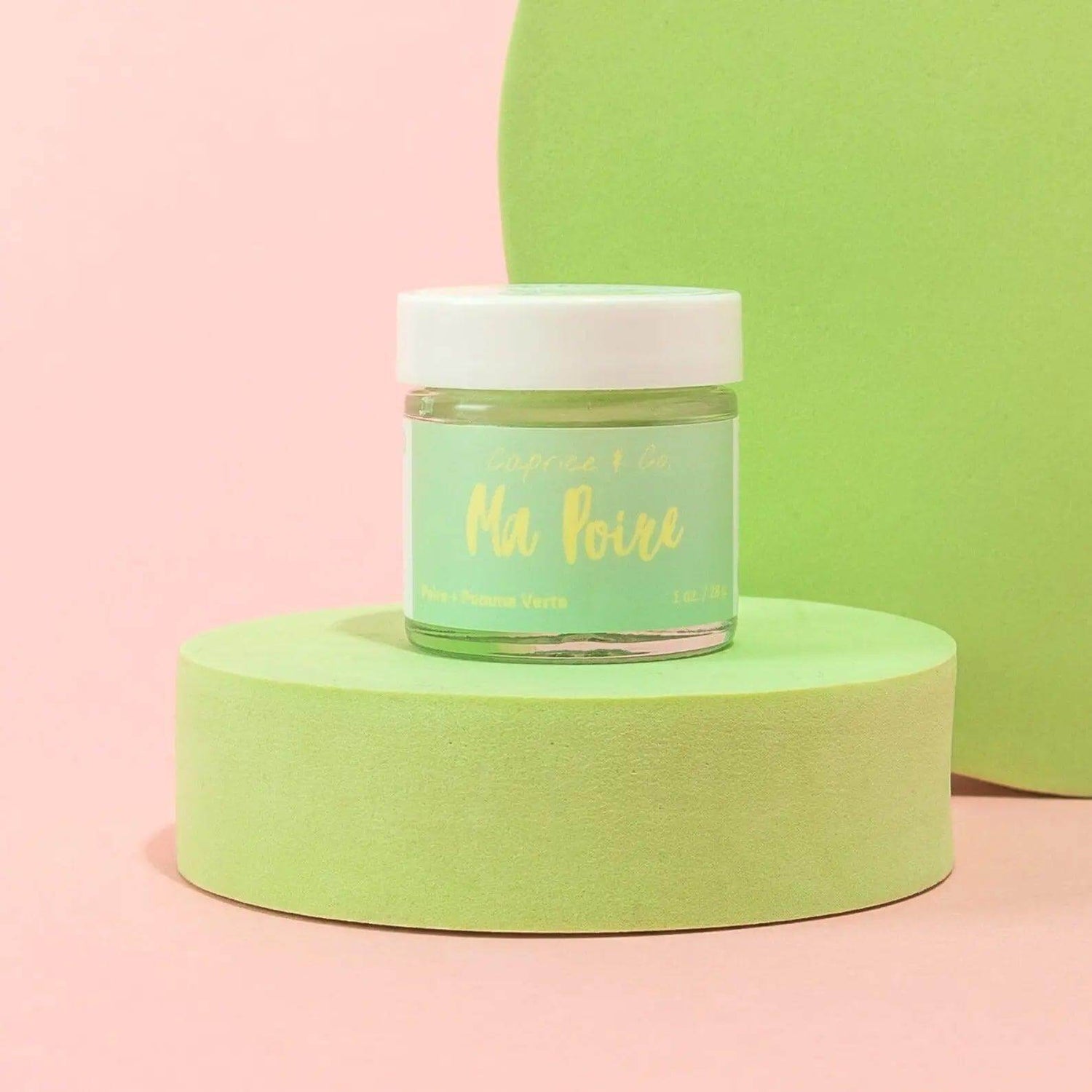 Lips Scrub Ma Poire jar with green and pink background, featuring pear and green apple flavors for lip exfoliation and hydration.