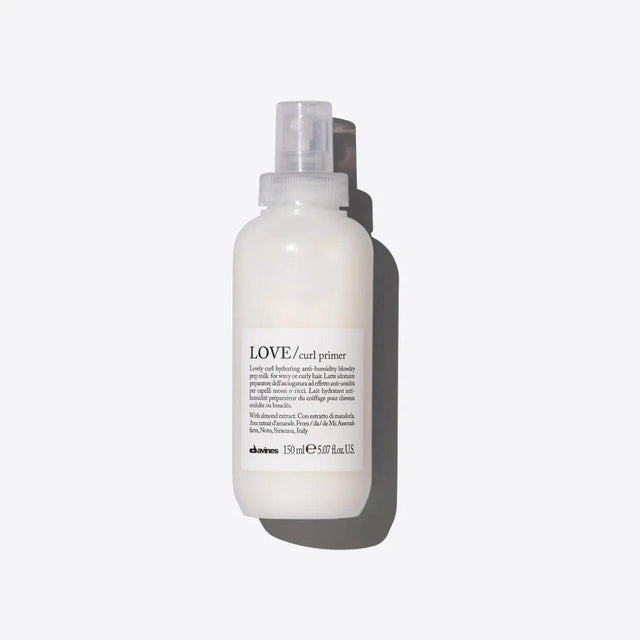 Davines Love Curl Primer product bottle for enhancing curly hair, reducing frizz, and boosting shine with nourishing ingredients.