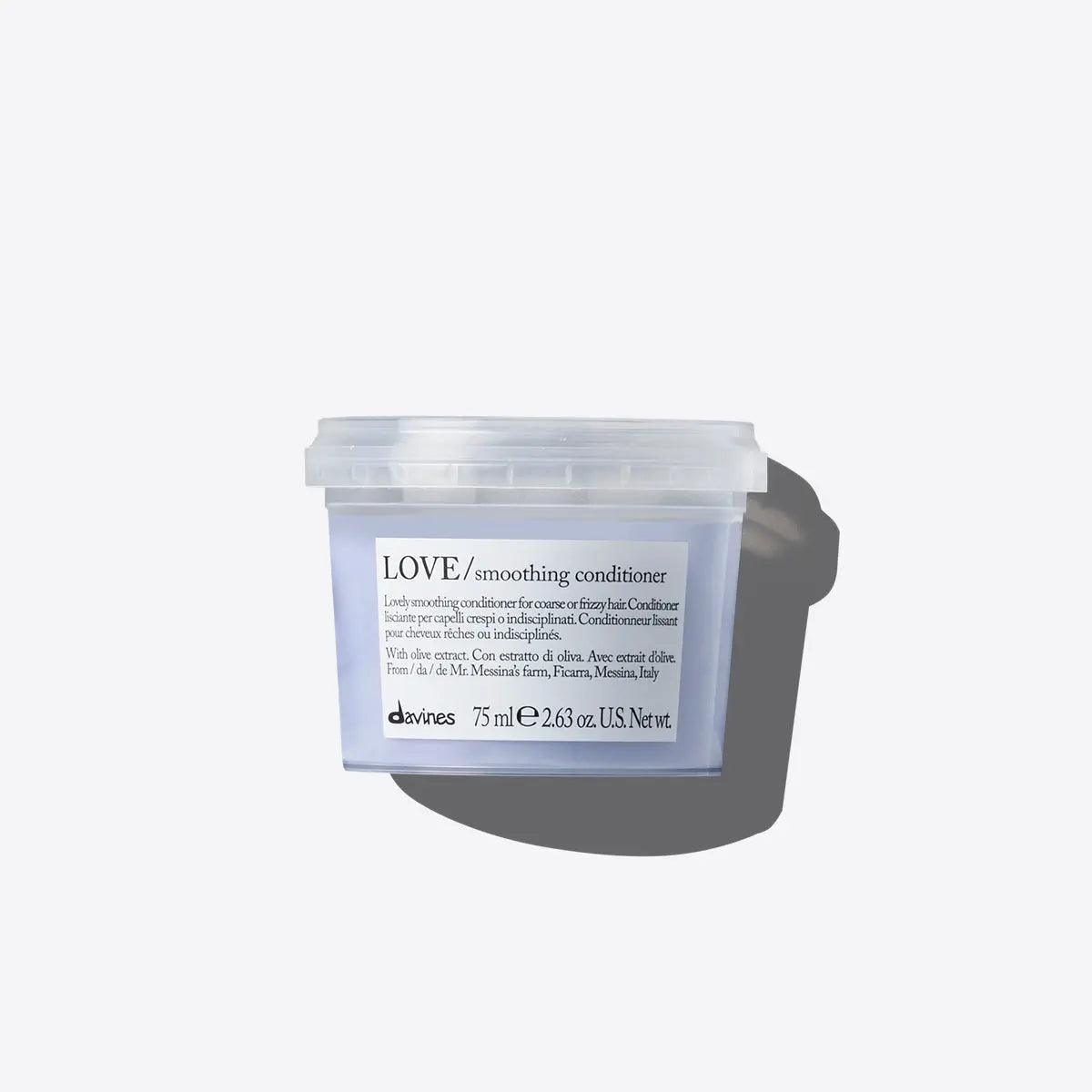 Davines Love Smoothing Conditioner for frizzy hair in clear container, offering nourishment and hydration for soft, manageable hair.