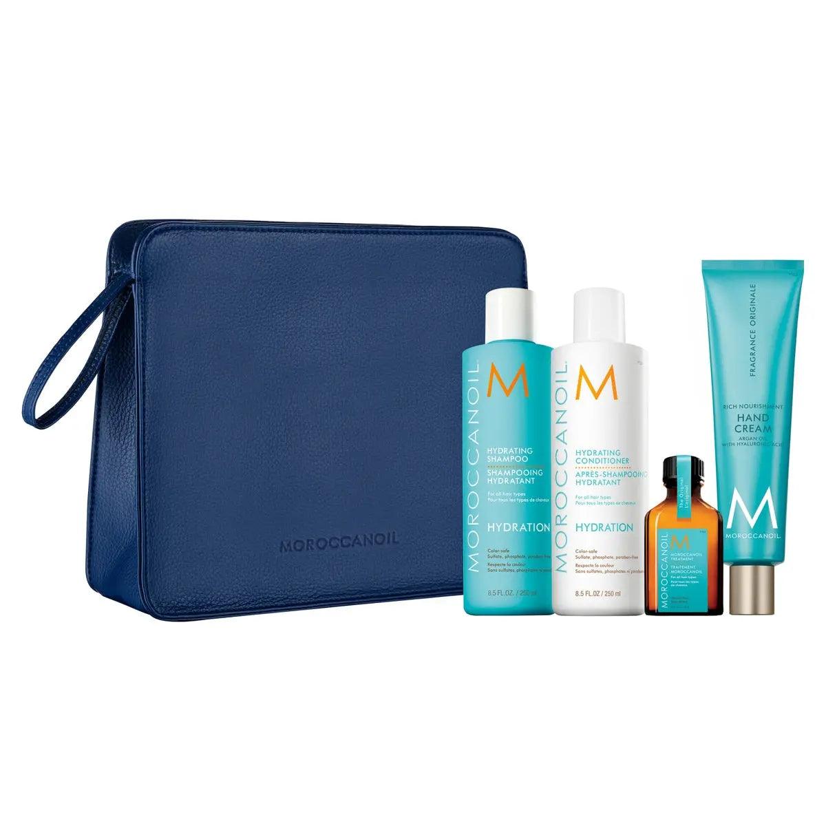 Luminous Wonders Hydration Set with Shampoo, Conditioner, Moroccanoil Treatment, and FREE Hand Cream in a blue cosmetic bag.