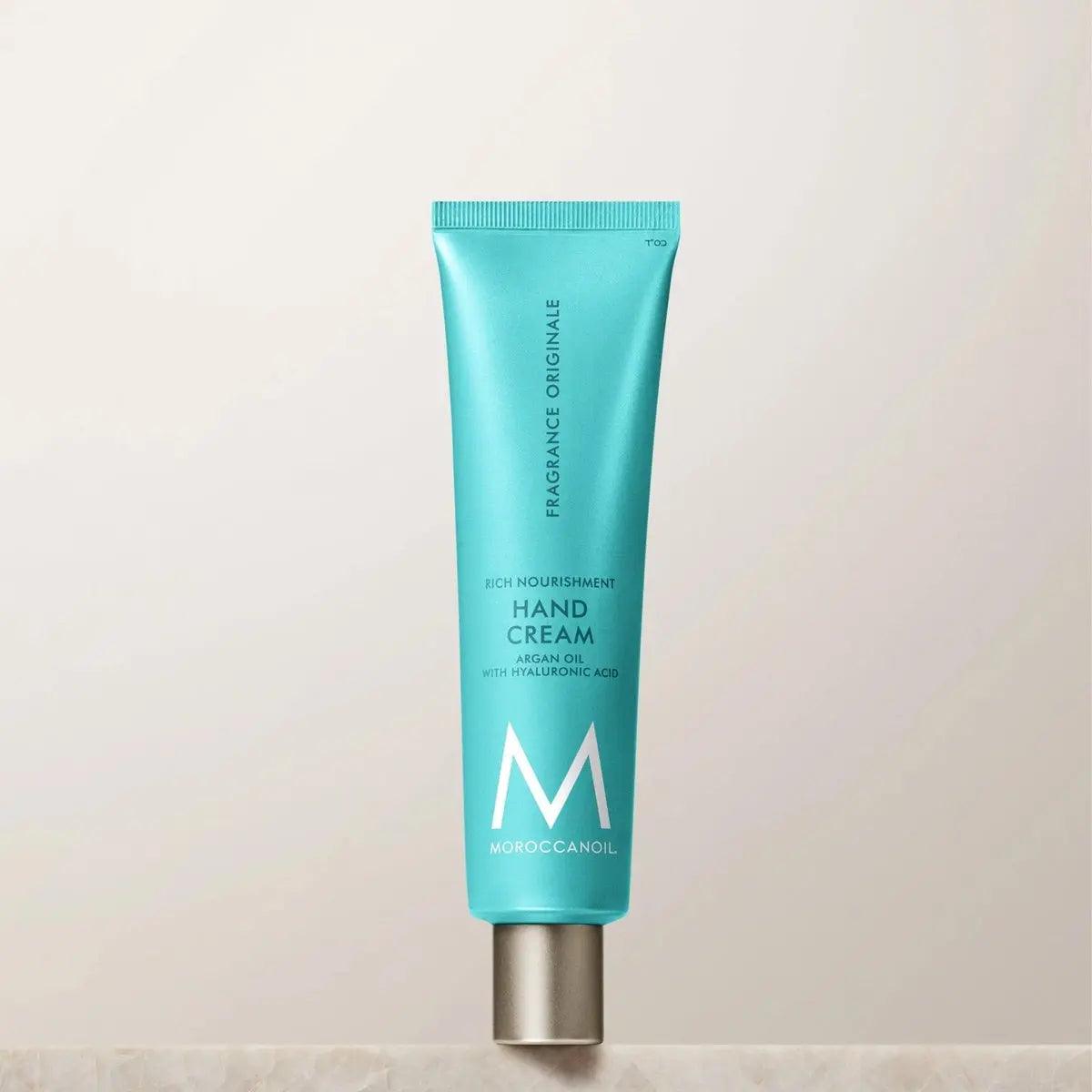 Moroccanoil Hand Cream Fragrance Originale tube on display, featuring argan oil and hyaluronic acid, ideal for nourishment and hydration.