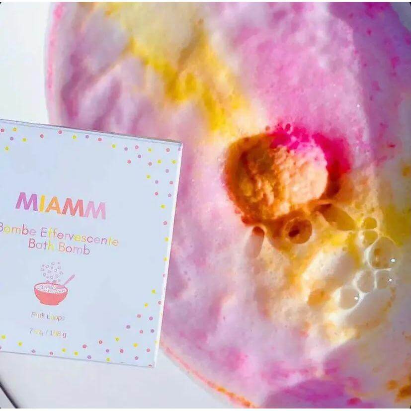 Miamm Bath Bomb XL in Fruit Loops scent with vibrant pink and yellow fizz in a bath, offering a soothing and hydrating experience.