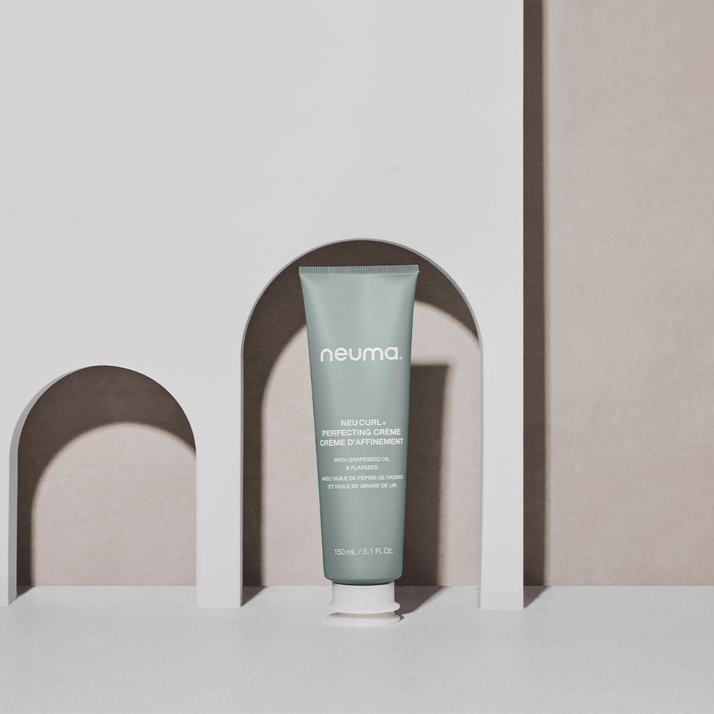 Neu Curl Perfecting Crème for enhancing natural curls, providing frizz-free hold, and nourishing with a coconut hibiscus aroma.